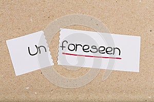 Sign with word unforeseen turned into foreseen photo