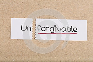 Sign with word unforgivable turned into forgivable