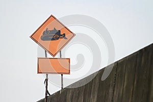 Sign for working tractor black symbol orange background