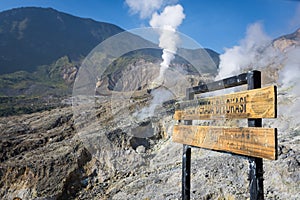 A sign written \'You are in the location of the Papandayan crater\' . A landscape of rocky track on mount Papandayan that