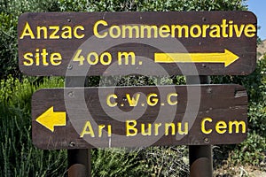 Signage at Anzac Cove at Gallipoli in Turkiye giving directions to the Anzac Commemorative site and Ari Burnu Cemetery.