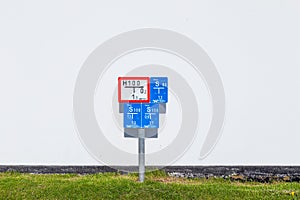 signage in blue and red to indicate deepness and position of sewerage and water pipes in public area