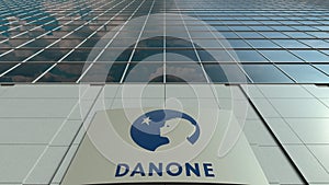 Signage board with Danone logo. Modern office building facade. Editorial 3D rendering
