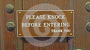A signage on the door saying knock first