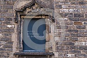 Signage of Museu D`Historia De Barcelona on Ancient Stone Window Frame