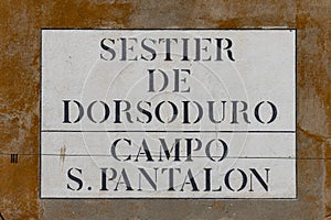 Signage sestier de Dorsoduro - Quarter Dorsoduro and Campo San Pantalon, Place of San Pantalon at the grunge wall in Venice photo