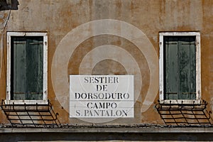 Signage sestier de Dorsoduro - Quarter Dorsoduro and Campo San Pantalon, Place of San Pantalon at the grunge wall in Venice photo