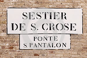 Signage sestier de S. Croce - quarter of San Croce - and Ponte San Pantalon - bridge of San Pantalon in Venice photo