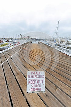 Signage on a wood planks flooring of a dock at Oceanside, California