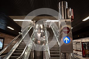 Signal light in front of escalator at the platform of underground train station.