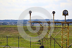 Signal poles in front of the runway, on the landing path.