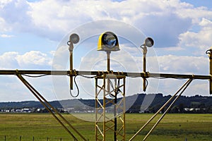 Signal poles in front of the runway, on the landing path.