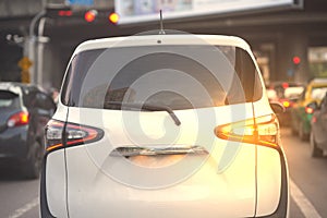 Signal sign of rear lamp of Back aspect of mini van car or family car on traffic road background