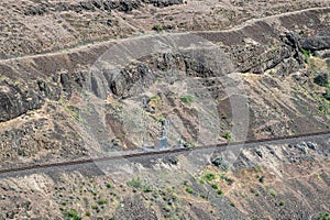 Signal switching equipment by the railroad tracks beneath the basalt cliffs along the Deschutes River in Oregon, USA