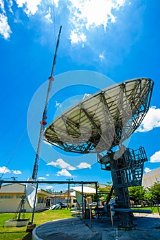Signal Tower and Sky satellite dish are large and the clouds are white as a backdrop, high telecommunication signal, wireless
