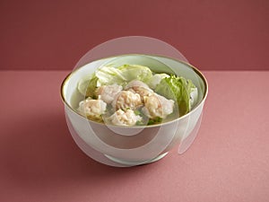 Signature Canton Jumbo Prawn Wanton soup with chopsticks served in a bowl isolated on mat side view on grey background