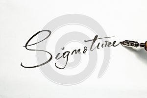 Signature word handwritten with a dip pen on white paper