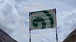 A signboard amidst the peaks in Kargil Mountain Highway, Not Runway.