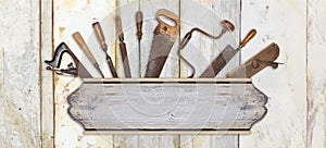 Signboard and carpenter tools on wooden background