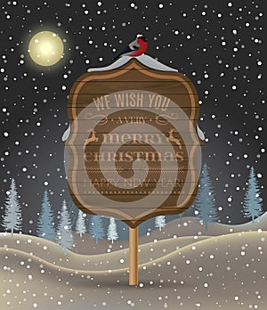 Signboard with Christmas greeting against a winter landscape with snow-covered forest and bullfinch. Holiday winter