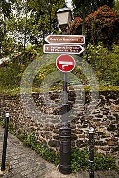 A signboard on the lamp in Montmartre, Paris