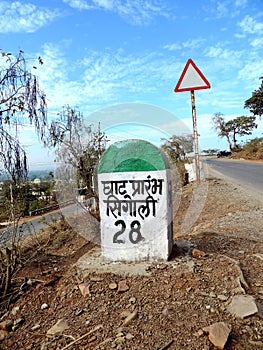 Signboard on the road showing start of the uphill climb of hill of Ratangarh Kheri in Madhya Pradesh, rural India tour photo