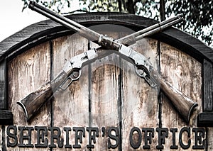 Signboard `Sheriff`s Office` with two old crossed lever rifles. photo