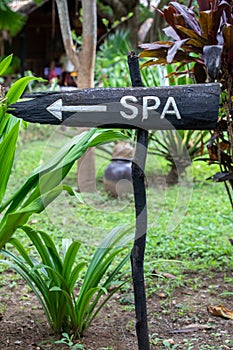 Signboard sign on wooden post with spa inscription.