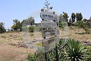 Signboard on Sinhagad Fort in Pune mentioning Fort name, a place to see nature, open theater