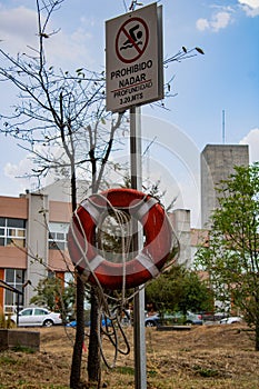 Signboard warning of prohibited swimming in the lake photo