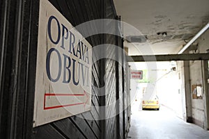 Signboard and yellow car in inner yard of building on Panska street