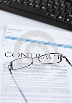 Signed contract paper with glasses