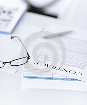 Signed contract paper with glasses photo