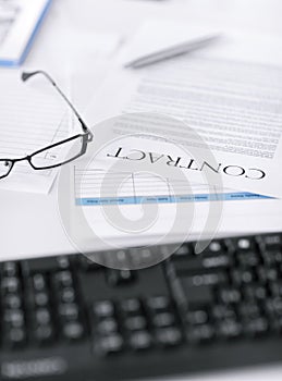 Signed contract paper with glasses