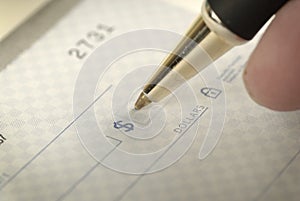 Signing a Check for Personal Finances photo