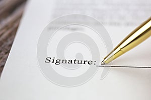 Signing a contract with signature with gold pen macro close-up, businessman,contract,deal,concept background