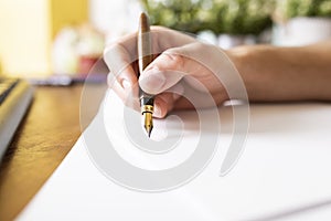 Signing a document. The man signs the document with a fountain pen