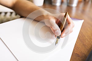 Signing a document. The man signs the document with a fountain pen