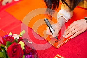Signing on the guestbook in a wedding