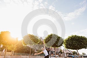 Signor man performs sports exercises in the park