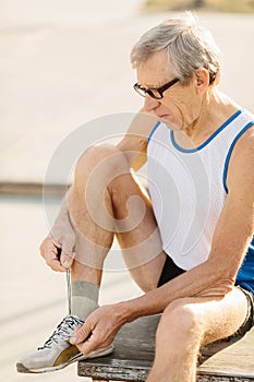 Signor man performs sports exercises in the park