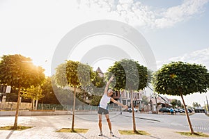 Signor man performs sports exercises in the park