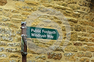 A signpost at Bourton on the water showing the Windrush way public footpath