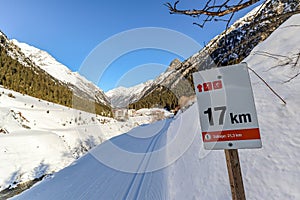 Signpost at Cross-country skiing trail through the Pitztal near Sankt Leonhard in Tirol, winter sports in snowy landscape in the