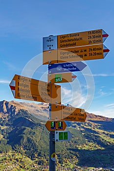 Signpost with directions to multiple destinations along the via alpina trail