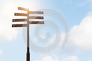 Signpost guide direction sign on a pole with blue sky backgrounds