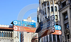Signpost with information arrows for city guests and tourists in Barcelona street
