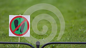 Signpost on the lawn does not walk on a background of lush green grass. close-up. copy space.Soft focus. blur
