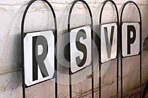 A signpost with letters spelling rsvp respondez s'il vous plait photo