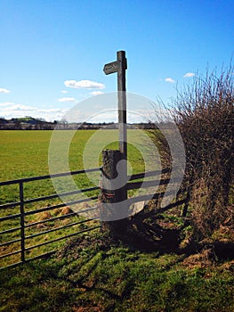 Signpost and rickety stile